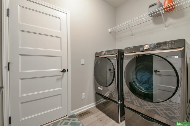 5017 N 209th St, Elkhorn, NE 68022 - washroom with washing machine and clothes dryer and light wood-type flooring