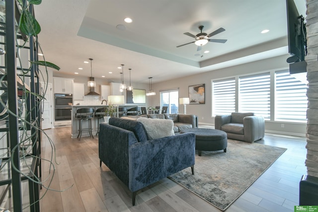 5017 N 209th St, Elkhorn, NE 68022 - living area with ceiling fan, recessed lighting, a tray ceiling, and light wood finished floors