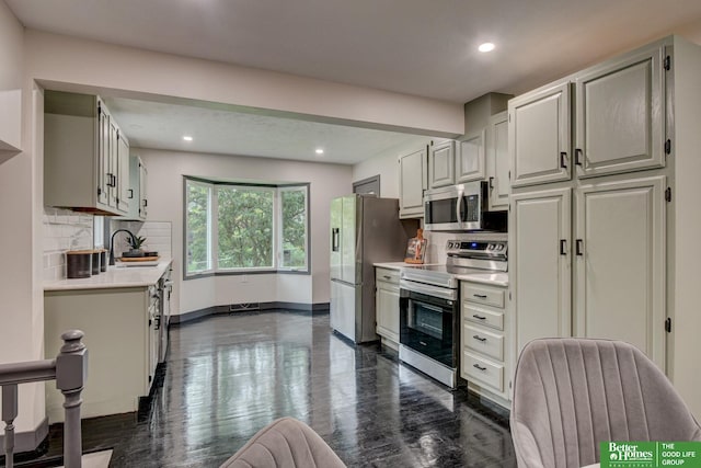 11680 Meredith Ave, Omaha, NE 68164 - kitchen with stainless steel appliances, light countertops, decorative backsplash, recessed lighting, and dark wood finished floors