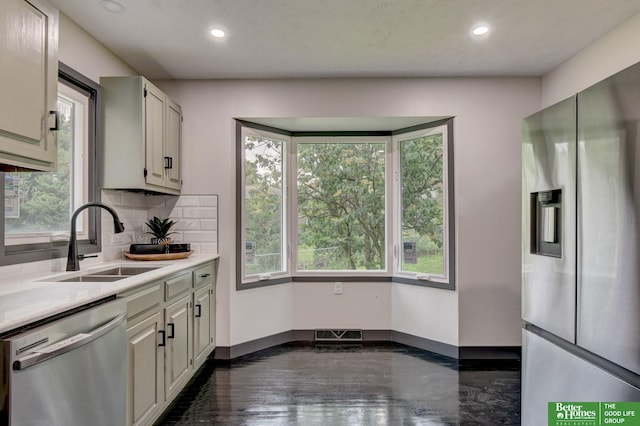 11680 Meredith Ave, Omaha, NE 68164 - kitchen with stainless steel appliances, light countertops, tasteful backsplash, and recessed lighting