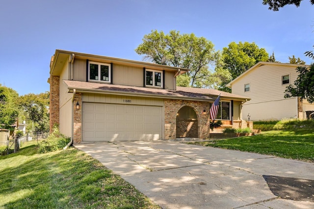 11680 Meredith Ave, Omaha, NE 68164 - view of front of house with driveway, a front yard, brick siding, and an attached garage