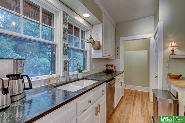 526 S 51st Ave, Omaha, NE 68132 - kitchen with stainless steel dishwasher, white cabinetry, light wood-type flooring, dark stone counters, and tasteful backsplash