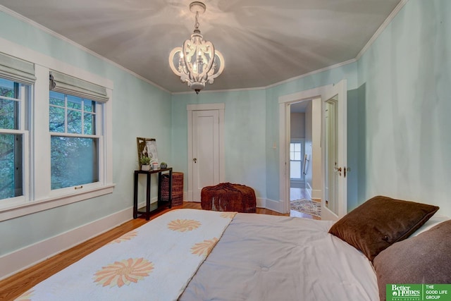 526 S 51st Ave, Omaha, NE 68132 - bedroom with a chandelier, multiple windows, ornamental molding, and wood finished floors