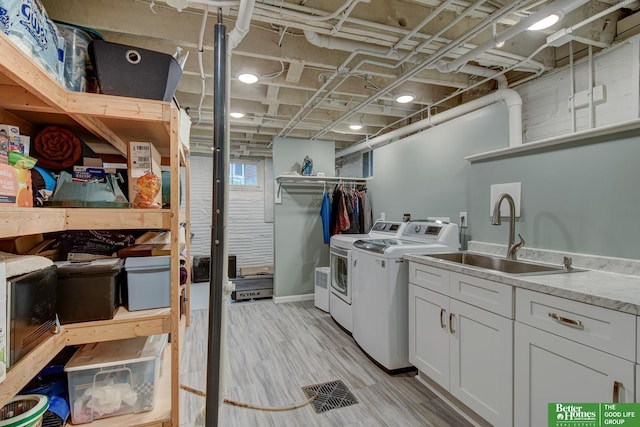 526 S 51st Ave, Omaha, NE 68132 - laundry room with washer and dryer, cabinet space, and light wood-style floors