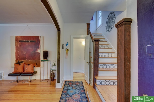 526 S 51st Ave, Omaha, NE 68132 - stairway with wood finished floors, arched walkways, and crown molding