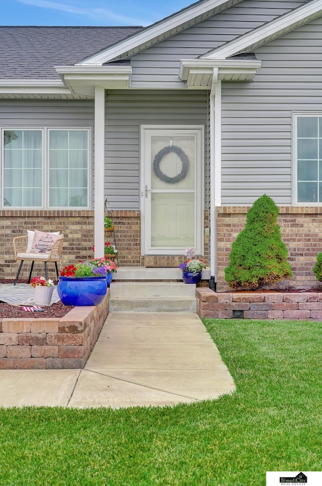 1015 Ridge Rd, Hickman, NE 68372 - entrance to property featuring brick siding and a lawn
