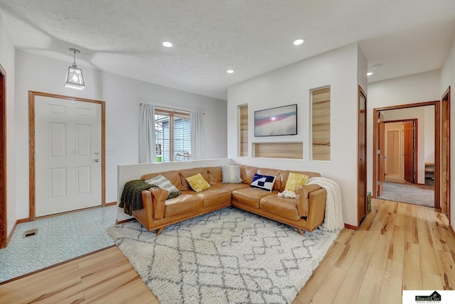 1015 Ridge Rd, Hickman, NE 68372 - living room featuring light wood finished floors, recessed lighting, and a textured ceiling
