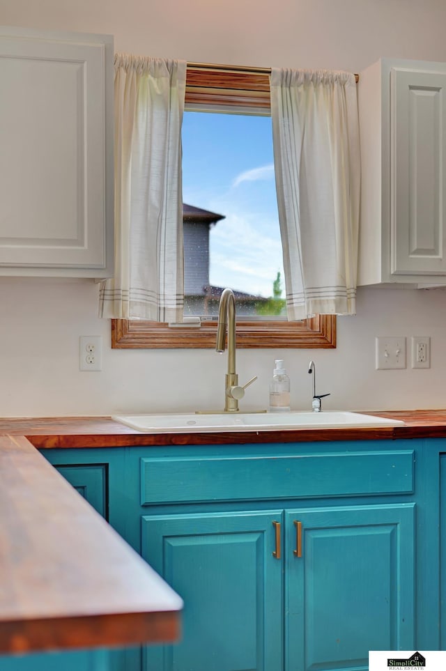 1015 Ridge Rd, Hickman, NE 68372 - kitchen with blue cabinetry and white cabinets