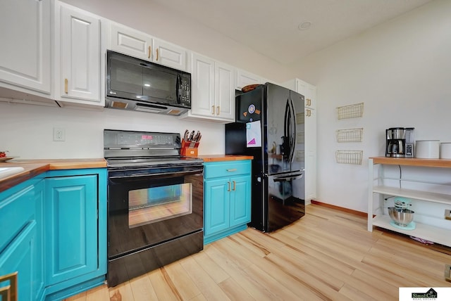 1015 Ridge Rd, Hickman, NE 68372 - kitchen with black appliances, light wood finished floors, white cabinets, and blue cabinetry