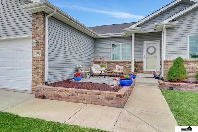 1015 Ridge Rd, Hickman, NE 68372 - doorway to property featuring brick siding and an attached garage