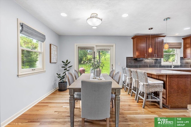 12079 Westover Rd, Omaha, NE 68154 - dining area featuring light wood-style floors, recessed lighting, and a textured ceiling