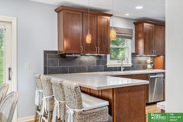 12079 Westover Rd, Omaha, NE 68154 - kitchen featuring dishwasher, a peninsula, tasteful backsplash, light stone countertops, and pendant lighting