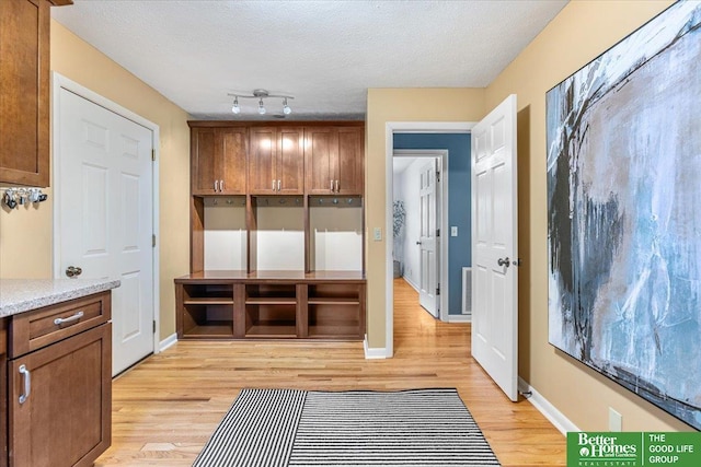 12079 Westover Rd, Omaha, NE 68154 - mudroom with light wood-type flooring and a textured ceiling