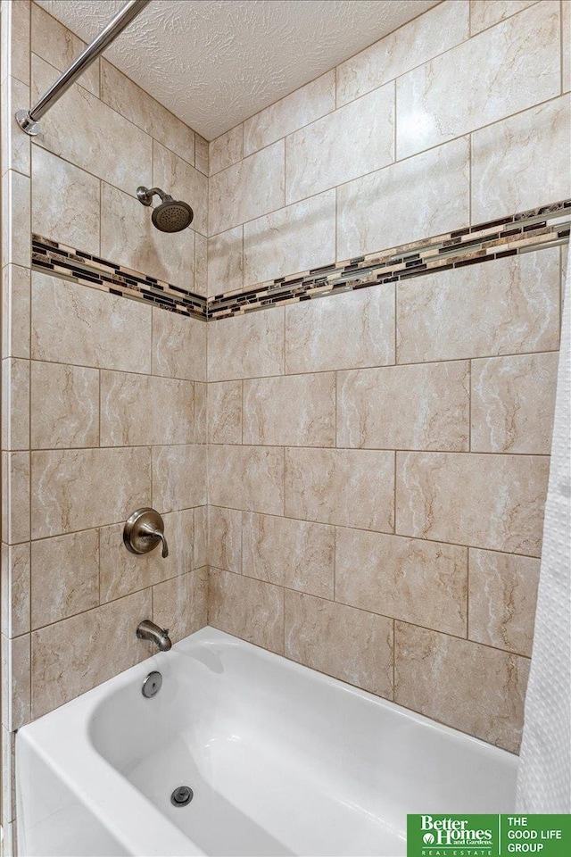 12079 Westover Rd, Omaha, NE 68154 - bathroom featuring shower / bathtub combination with curtain and a textured ceiling