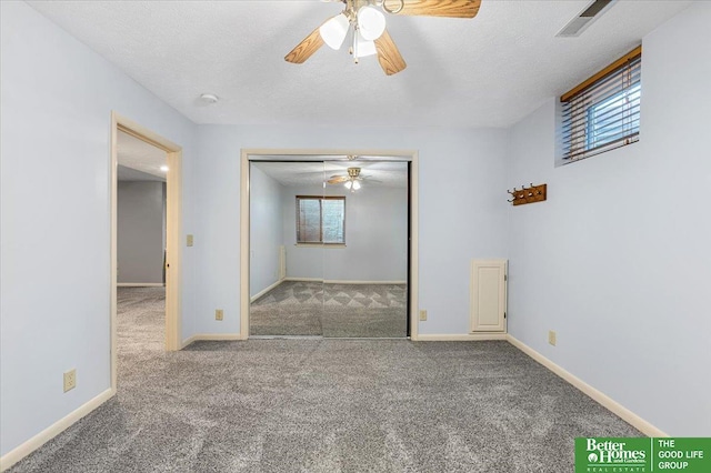12079 Westover Rd, Omaha, NE 68154 - empty room with a ceiling fan, healthy amount of natural light, carpet, and a textured ceiling