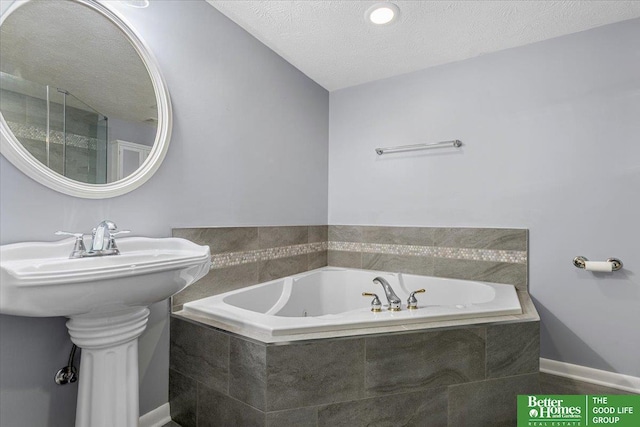 12079 Westover Rd, Omaha, NE 68154 - bathroom featuring a jetted tub and a textured ceiling