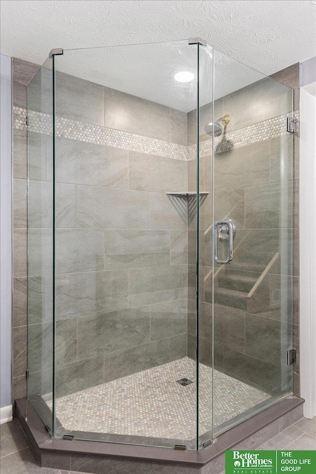 12079 Westover Rd, Omaha, NE 68154 - full bath with a shower stall, tile patterned flooring, and a textured ceiling