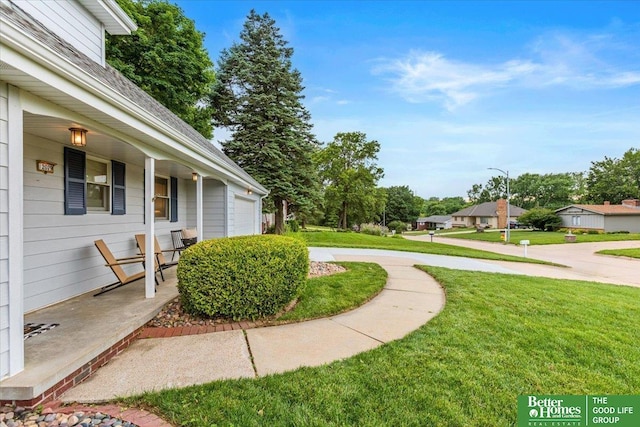 12079 Westover Rd, Omaha, NE 68154 - view of green lawn featuring covered porch and an attached garage
