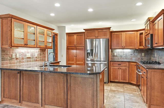 10505 S 179th St, Omaha, NE 68136 - kitchen featuring stainless steel appliances, brown cabinetry, a peninsula, backsplash, and recessed lighting