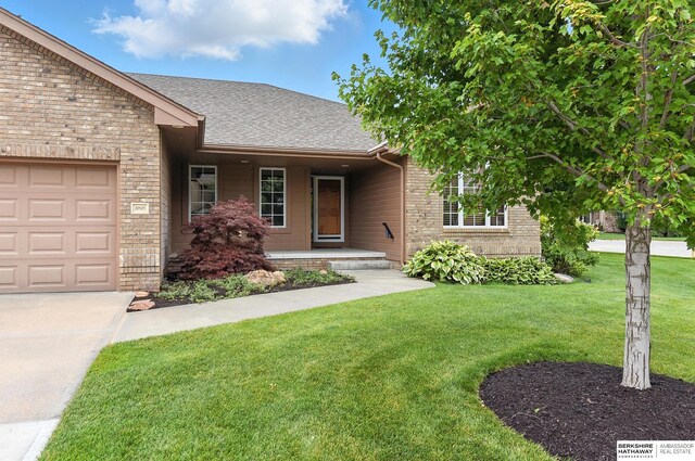 10505 S 179th St, Omaha, NE 68136 - view of front of house featuring a porch, brick siding, a shingled roof, a front lawn, and concrete driveway