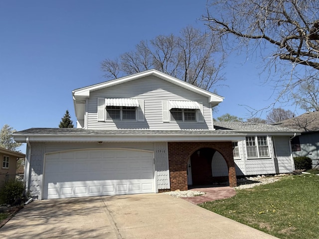 13910 Shirley St, Omaha, NE 68144 - split level home with driveway, an attached garage, a front yard, a shingled roof, and brick siding