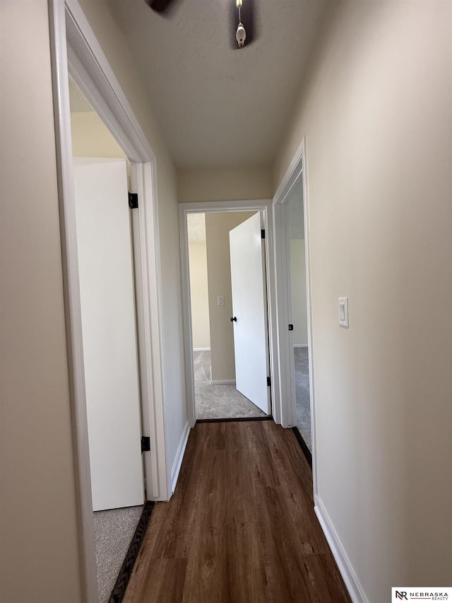 13910 Shirley St, Omaha, NE 68144 - hall featuring dark wood-type flooring and baseboards