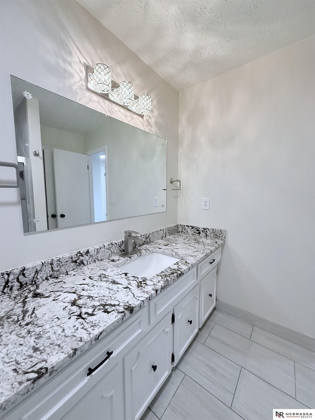 13910 Shirley St, Omaha, NE 68144 - bathroom with vanity and a textured ceiling