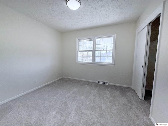 13910 Shirley St, Omaha, NE 68144 - unfurnished bedroom with a textured ceiling, carpet flooring, and a closet
