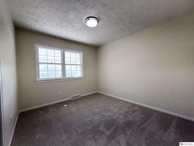 13910 Shirley St, Omaha, NE 68144 - spare room with dark colored carpet and a textured ceiling