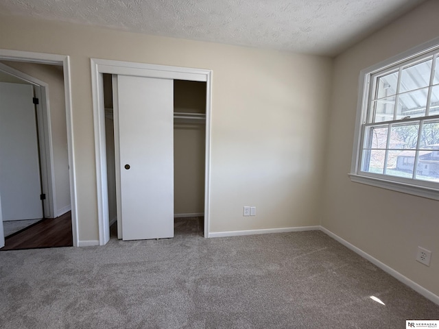 13910 Shirley St, Omaha, NE 68144 - unfurnished bedroom featuring carpet floors, a closet, and a textured ceiling