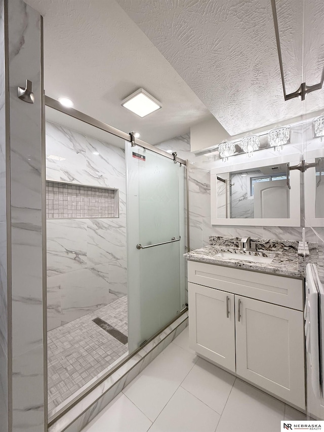 13910 Shirley St, Omaha, NE 68144 - bathroom featuring a marble finish shower, vanity, a textured ceiling, and marble look tile flooring