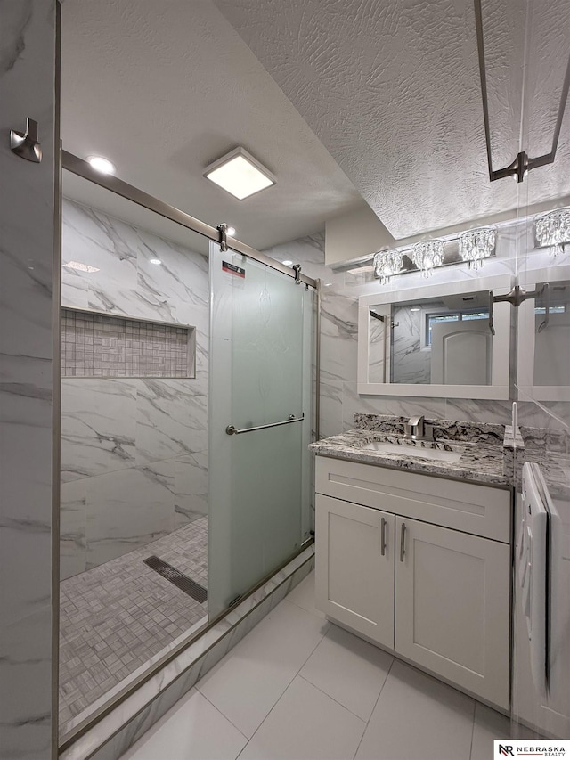 13910 Shirley St, Omaha, NE 68144 - bathroom featuring a marble finish shower, vanity, washer / dryer, marble finish floors, and a textured ceiling