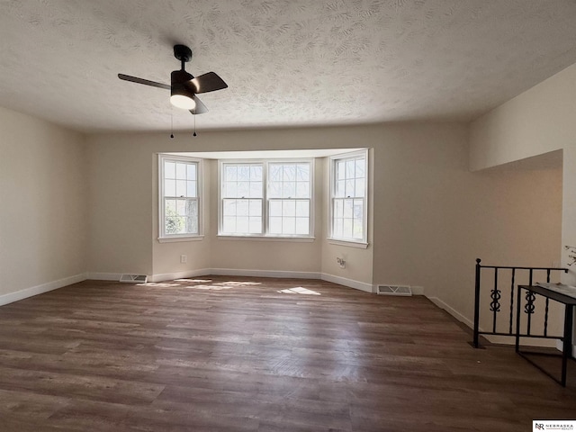 13910 Shirley St, Omaha, NE 68144 - spare room featuring a ceiling fan, dark wood finished floors, and a textured ceiling