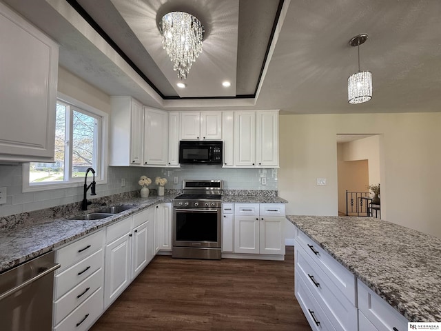 13910 Shirley St, Omaha, NE 68144 - kitchen with appliances with stainless steel finishes, a chandelier, dark wood-style flooring, white cabinetry, and recessed lighting
