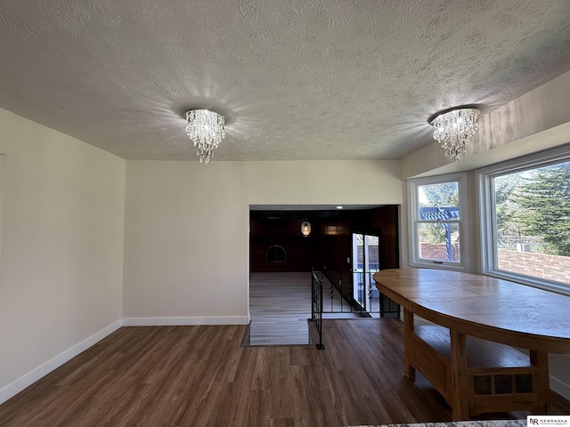 13910 Shirley St, Omaha, NE 68144 - dining space featuring a chandelier, wood finished floors, and a textured ceiling