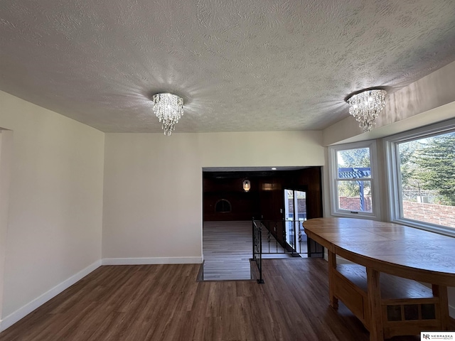 13910 Shirley St, Omaha, NE 68144 - dining space with a chandelier, wood finished floors, and a textured ceiling