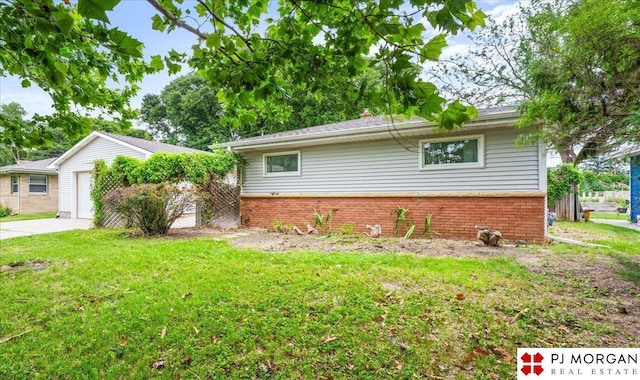 625 S 67th St, Omaha, NE 68106 - view of front of home featuring brick siding, a front lawn, and driveway