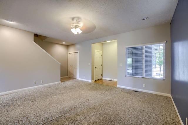 1215 Turtle Creek Rd, Lincoln, NE 68521 - carpeted empty room featuring a ceiling fan, a textured ceiling, and stairs