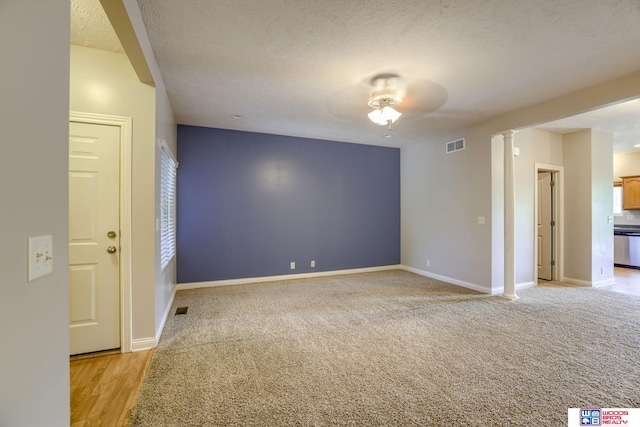 1215 Turtle Creek Rd, Lincoln, NE 68521 - empty room featuring a textured ceiling, decorative columns, and light carpet
