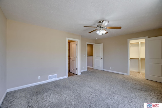 1215 Turtle Creek Rd, Lincoln, NE 68521 - unfurnished bedroom featuring carpet flooring, a walk in closet, a ceiling fan, and a closet