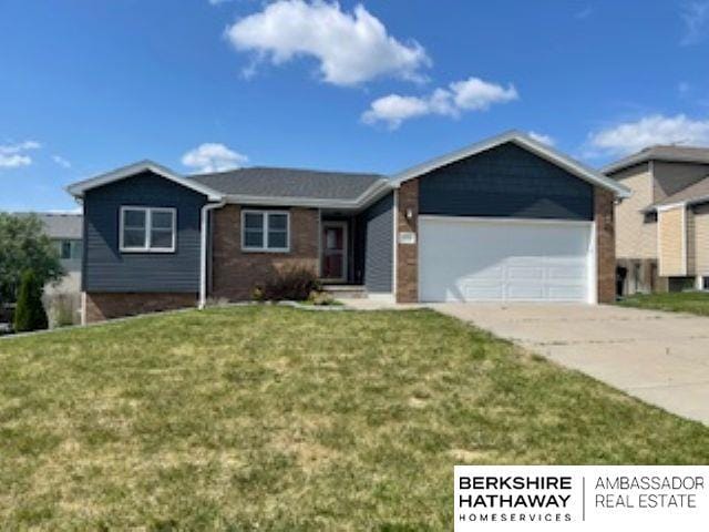 220 Orchard Pl, Hickman, NE 68372 - ranch-style home featuring a garage, driveway, a front lawn, and brick siding