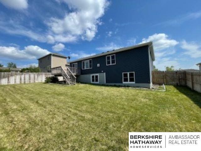 220 Orchard Pl, Hickman, NE 68372 - back of house featuring a fenced backyard, stairs, and a wooden deck