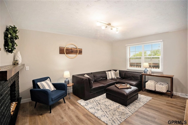 1913 Winnie Dr Unit 5, Bellevue, NE 68005 - living room featuring a textured ceiling, wood finished floors, and a fireplace
