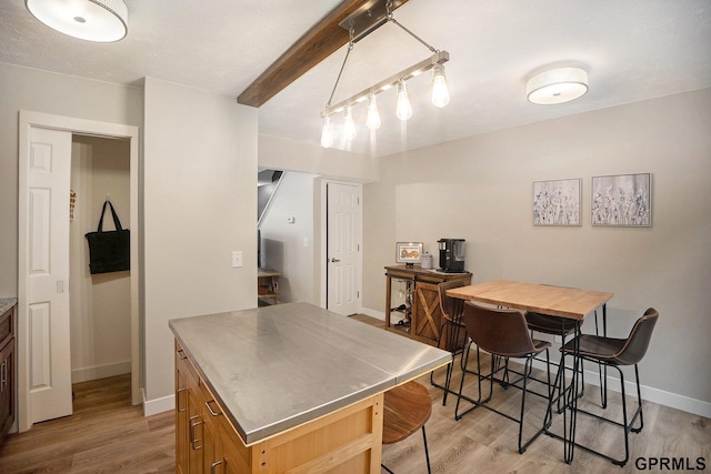1913 Winnie Dr Unit 5, Bellevue, NE 68005 - kitchen featuring stainless steel counters, light wood-type flooring, a center island, and a kitchen bar