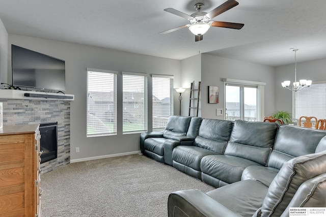 14562 Potter Cir, Bennington, NE 68007 - living area with a chandelier, carpet floors, a ceiling fan, and a stone fireplace