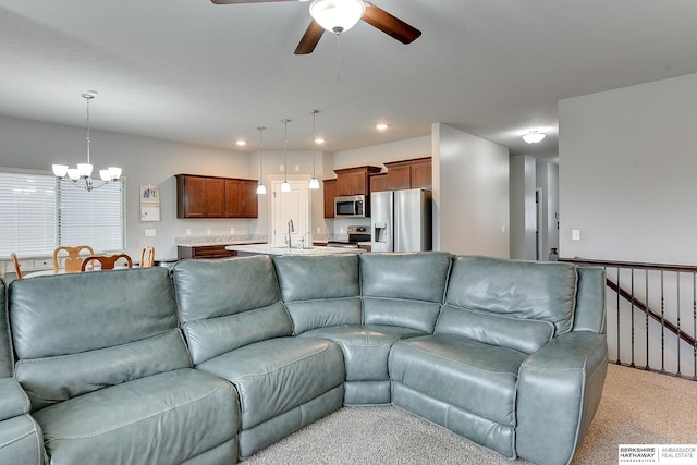14562 Potter Cir, Bennington, NE 68007 - living room with a chandelier, a ceiling fan, light colored carpet, and recessed lighting