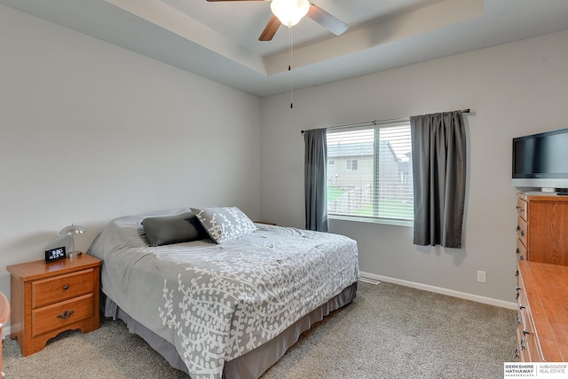 14562 Potter Cir, Bennington, NE 68007 - bedroom with a tray ceiling, light carpet, and ceiling fan