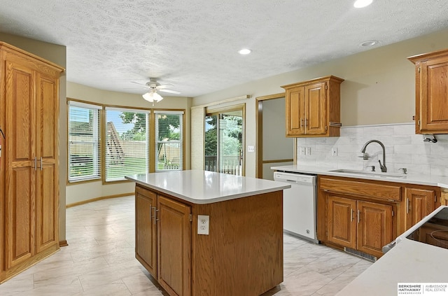 1422 N 155th Ave, Omaha, NE 68154 - kitchen with dishwasher, ceiling fan, a center island, light countertops, and brown cabinetry