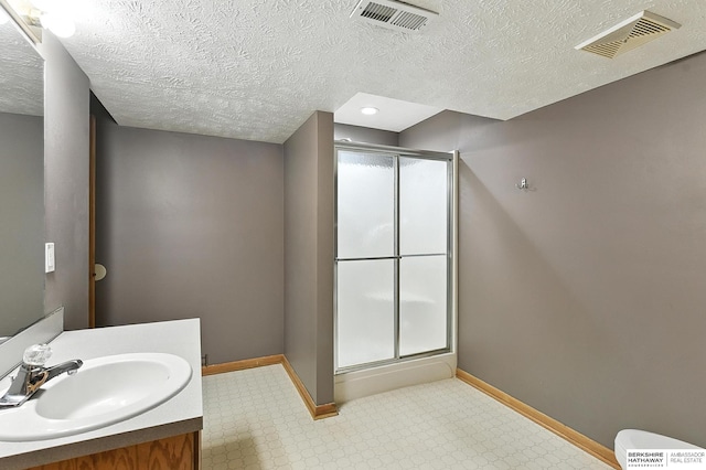1422 N 155th Ave, Omaha, NE 68154 - bathroom with a shower stall, tile patterned floors, vanity, and a textured ceiling