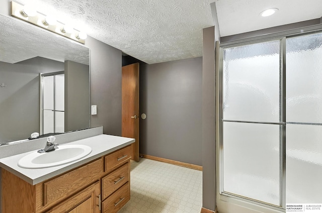 1422 N 155th Ave, Omaha, NE 68154 - bathroom with a shower stall, vanity, tile patterned floors, and a textured ceiling